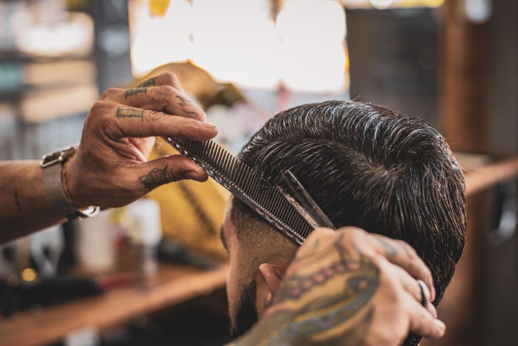 Einem Mann werden die Haare geschnitten